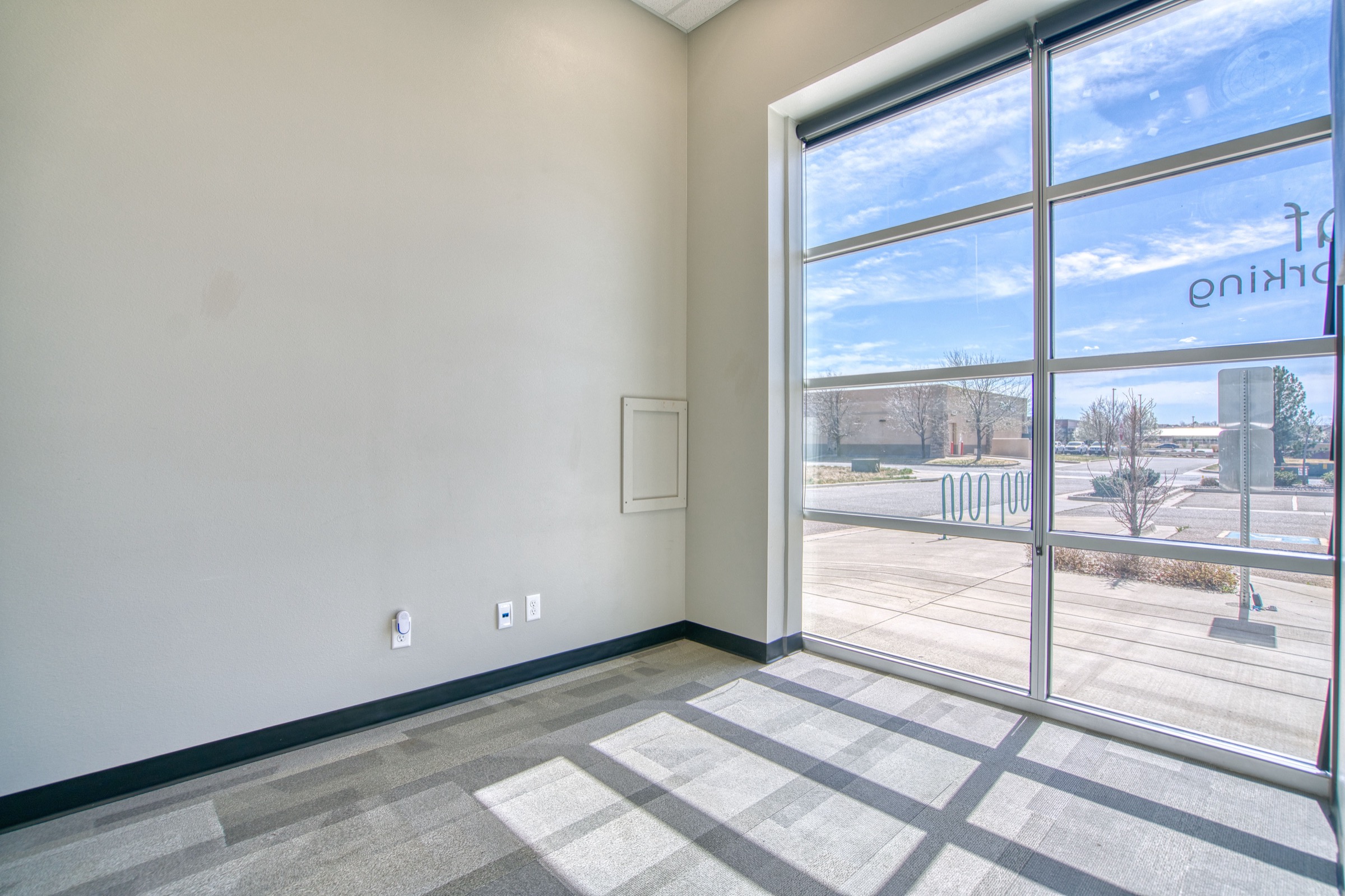 Bright unfurnished office suite with floor-to-ceiling windows flooding the room with natural light